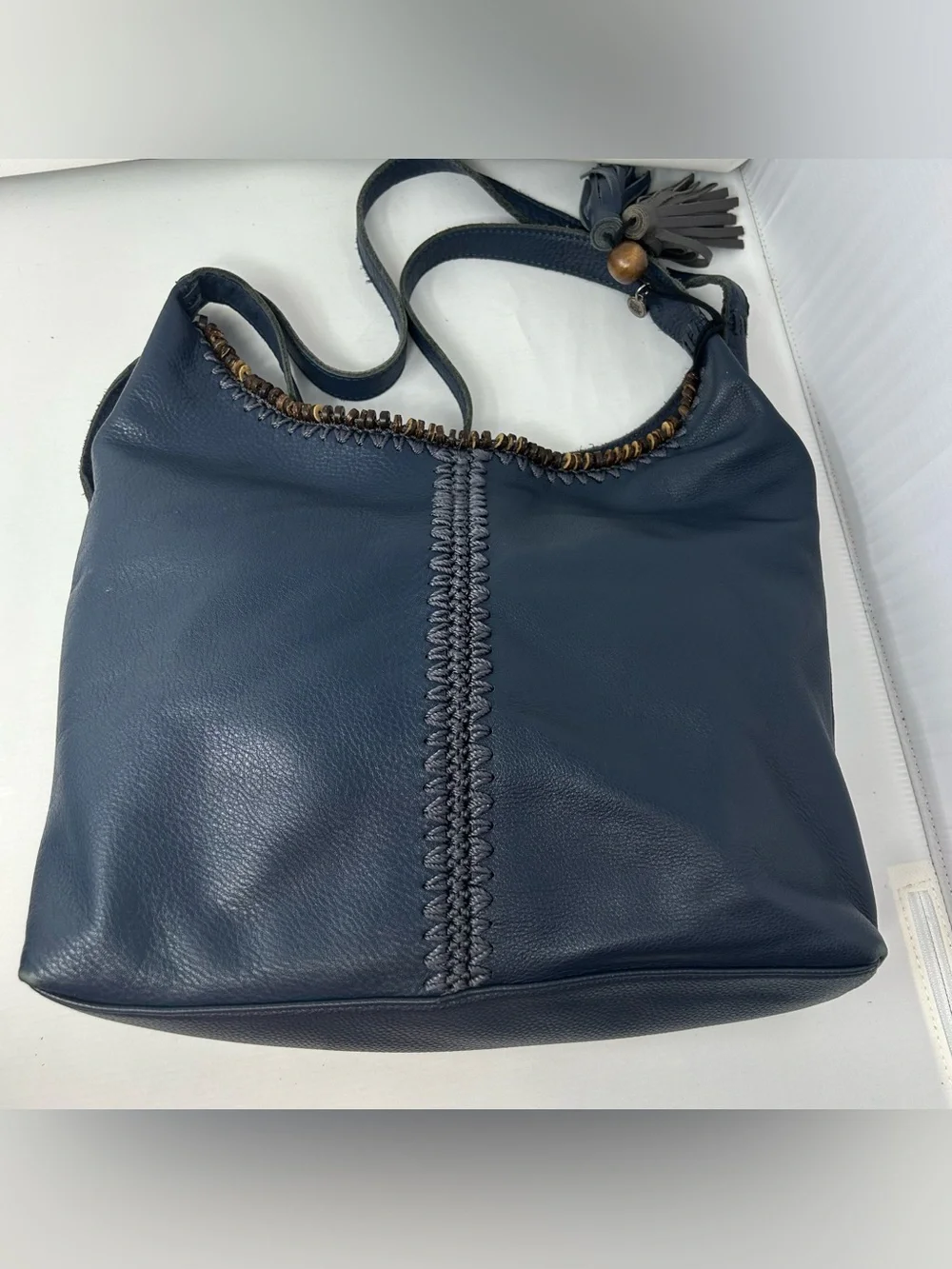 The Sak Boho Leather Hobo Bag slouchy with Beaded Trim and Tassel charm Blue